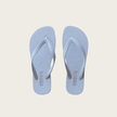 Pair of cornflower blue Sandos flip-flops on a beige background