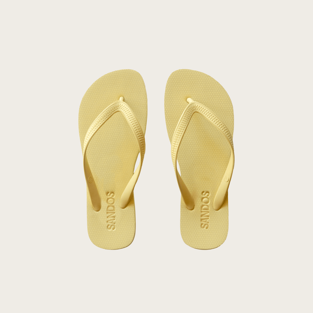 Pair of Limoncello Sandos flip-flops on a light gray background