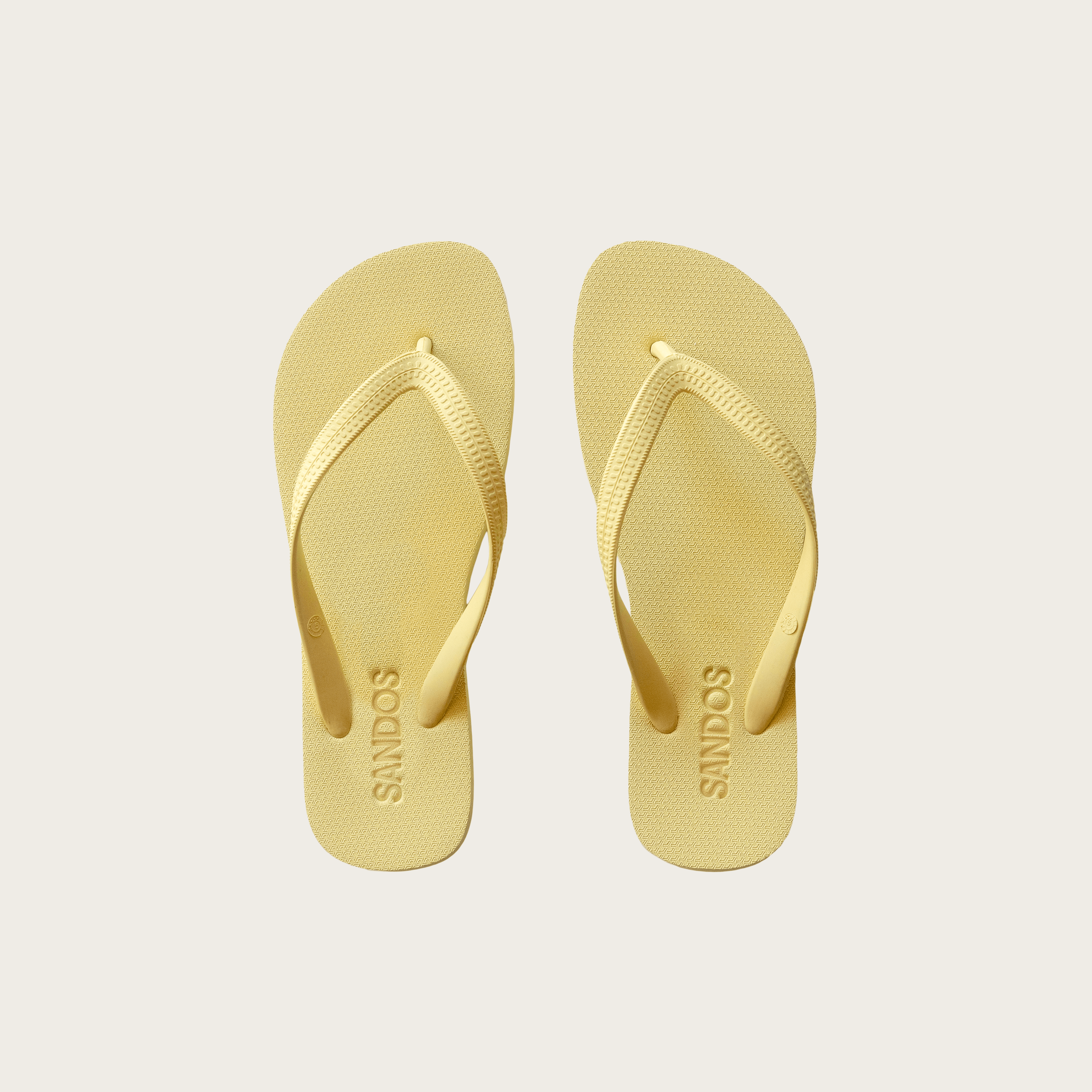 Pair of Limoncello Sandos flip-flops on a light gray background