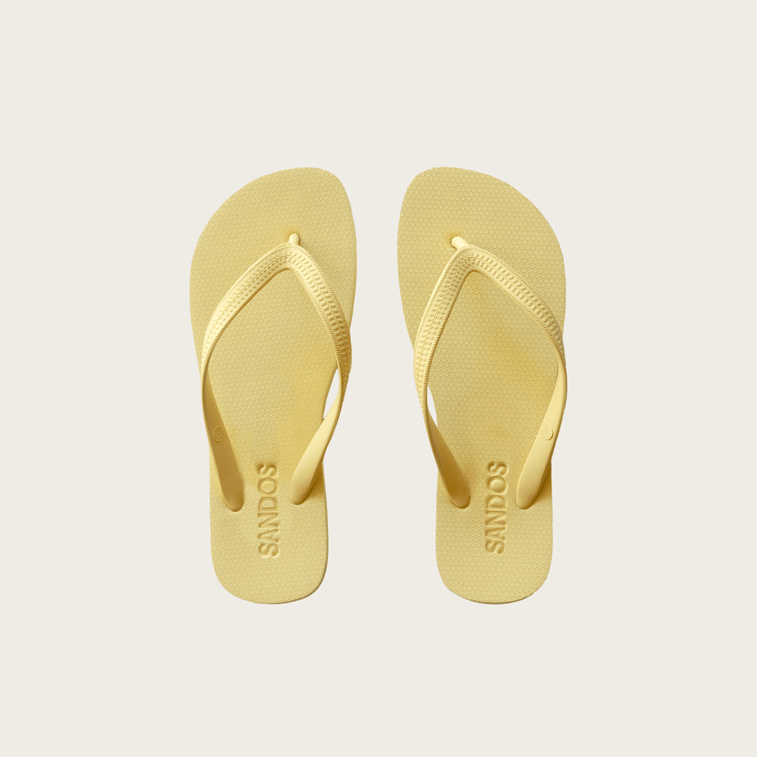 Pair of Limoncello Sandos flip-flops on a light gray background